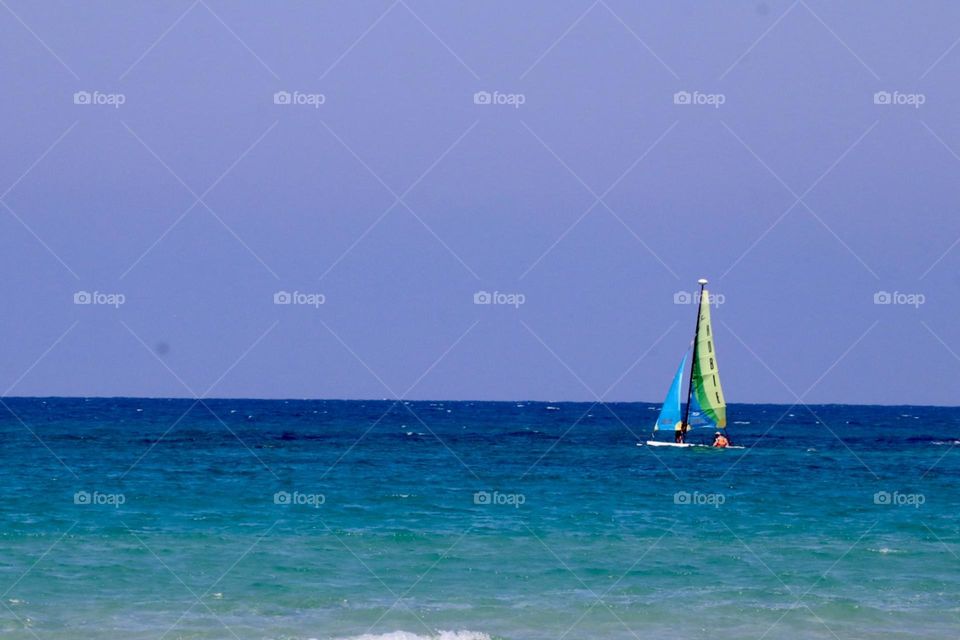 Sail boat on blue sea with blue sky