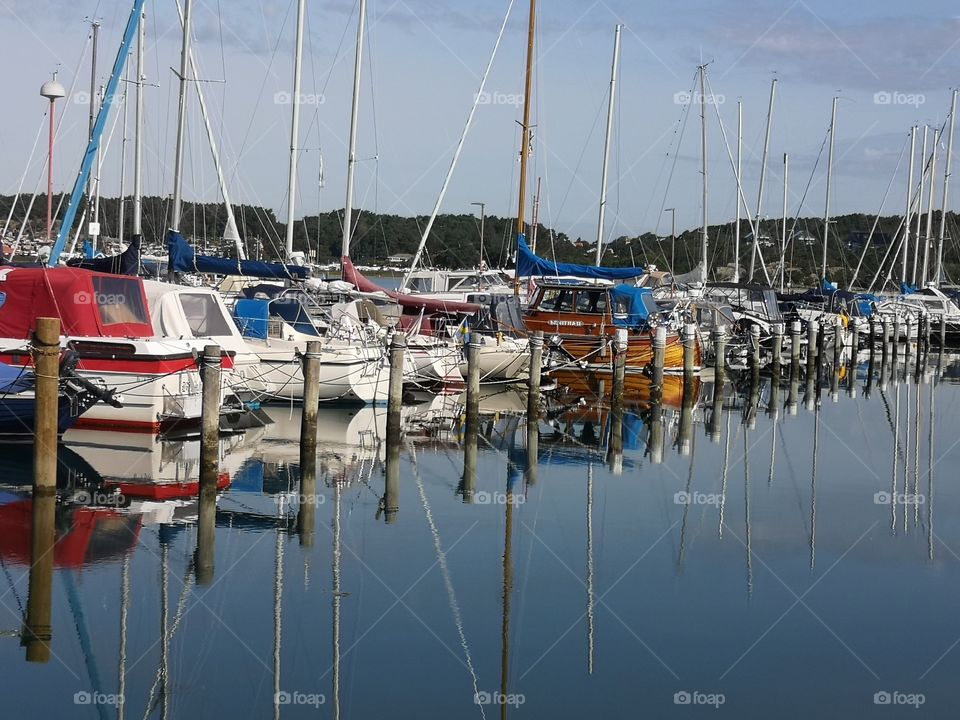 Ship harbor.  Ships are reflected in the water. Beautiful mirroring