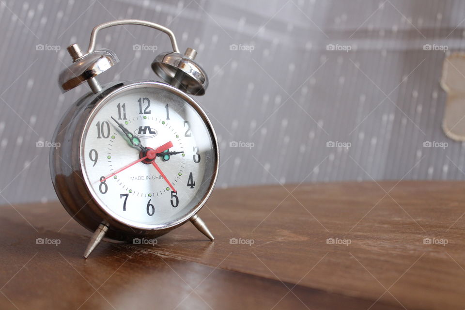 old vintage clock on the wooden table