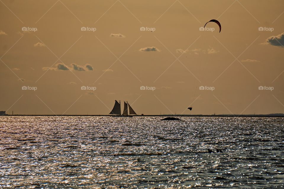 Man wind surfing in high air during a sunset 