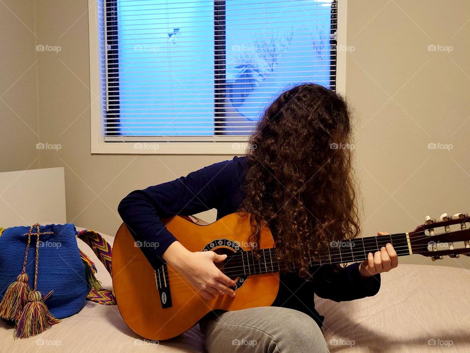 playing guitar inside because is snowing
