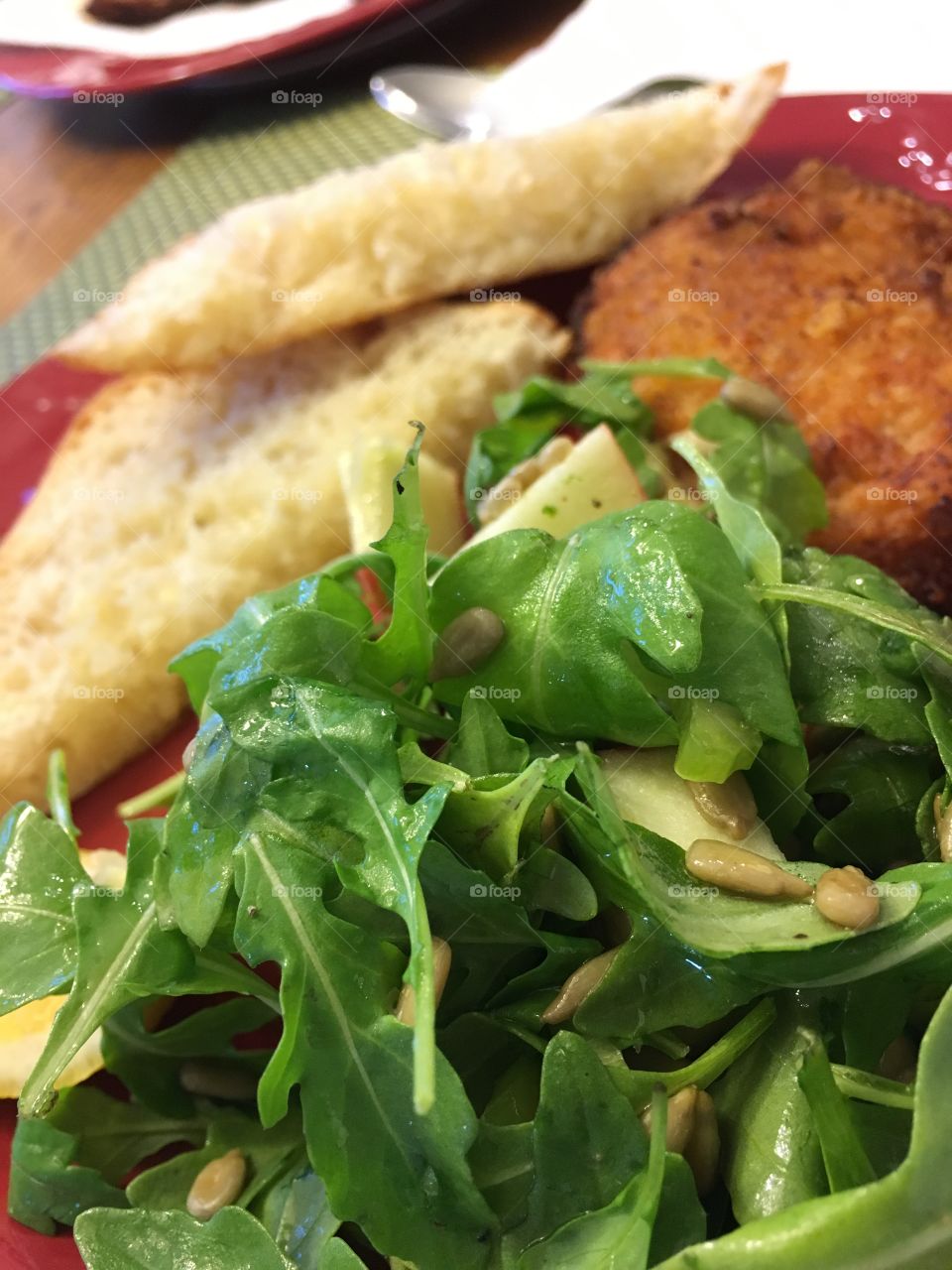 Salad, bread and pork chop dinner