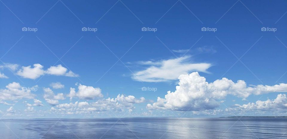 clouds over water on a sunny day