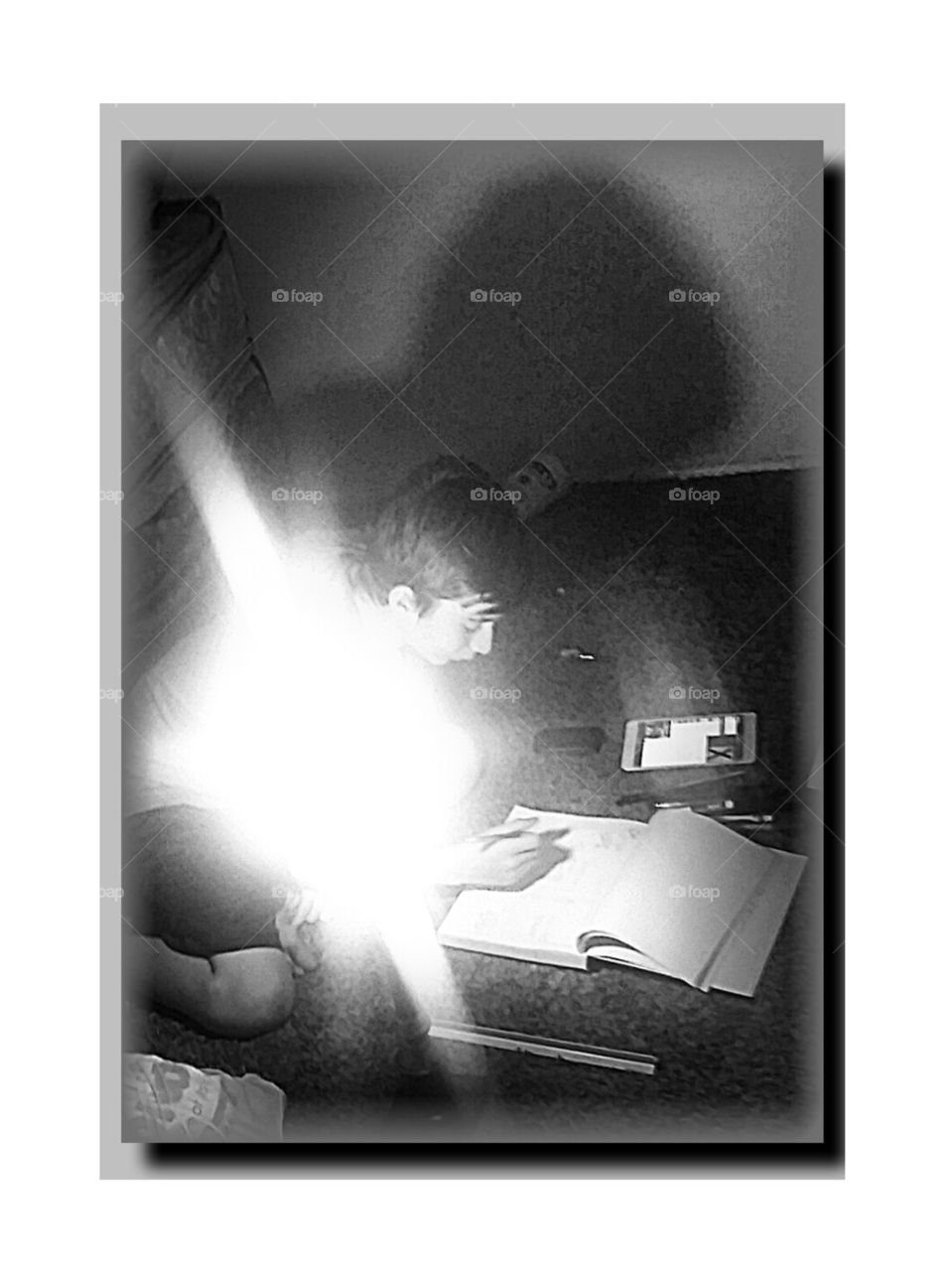 burning midnight oil. my son moved into sister's old room. In the midst of barren space, illuminated by shadeless lamp, he  is hard at work