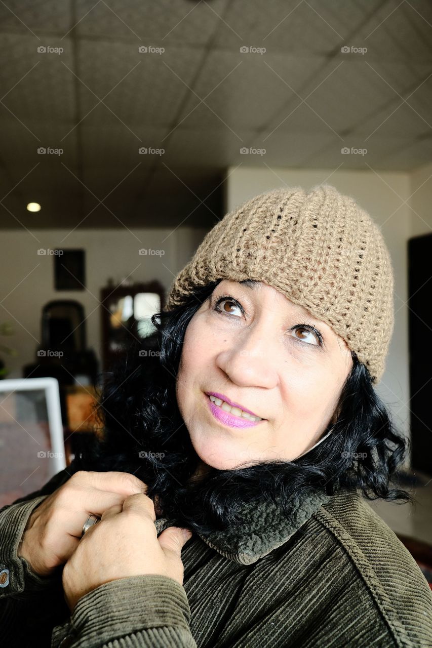 Warm woman wearing a wool jacket and hat in the middle of autumn.