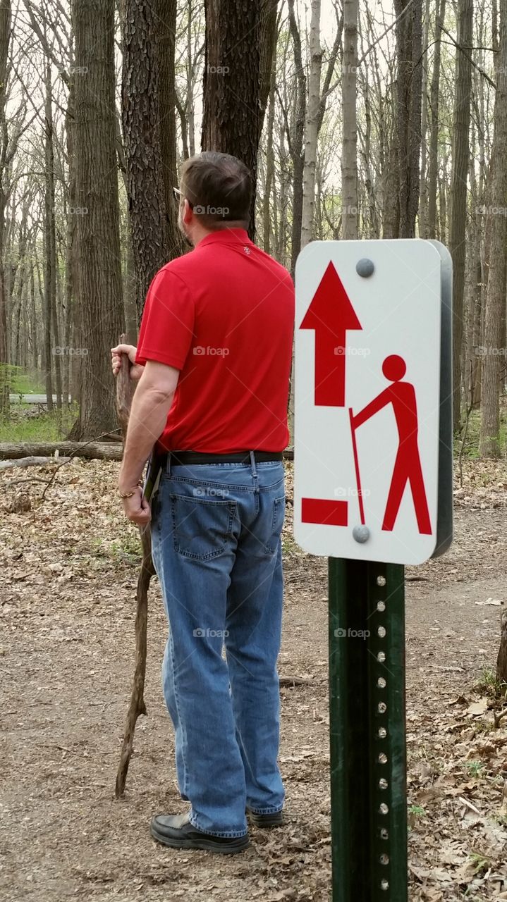 A hiker accidentally imitating a sign