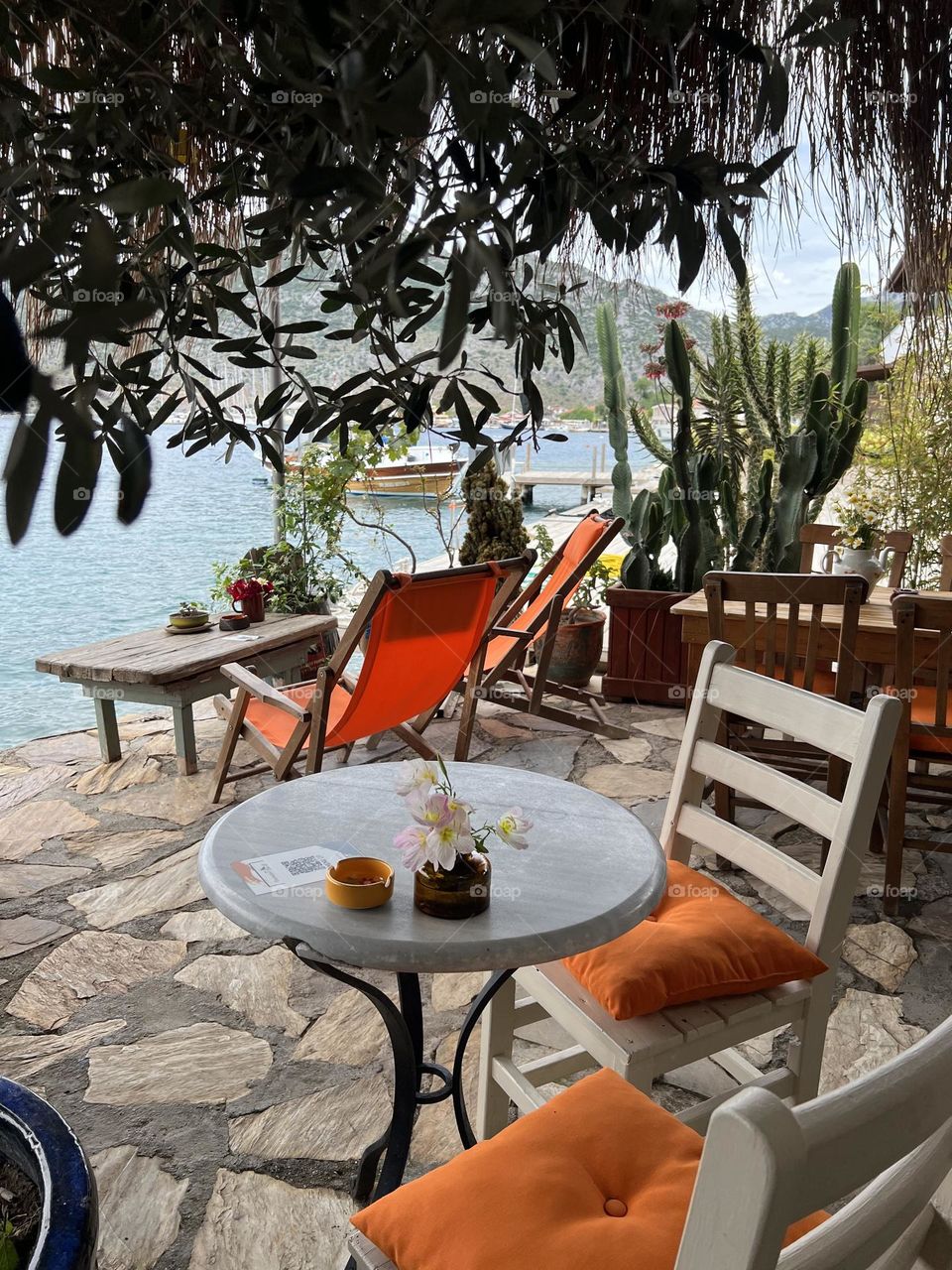 Summer cafe terrace, orange chairs, beach bar, boho cafe, cactus garden 