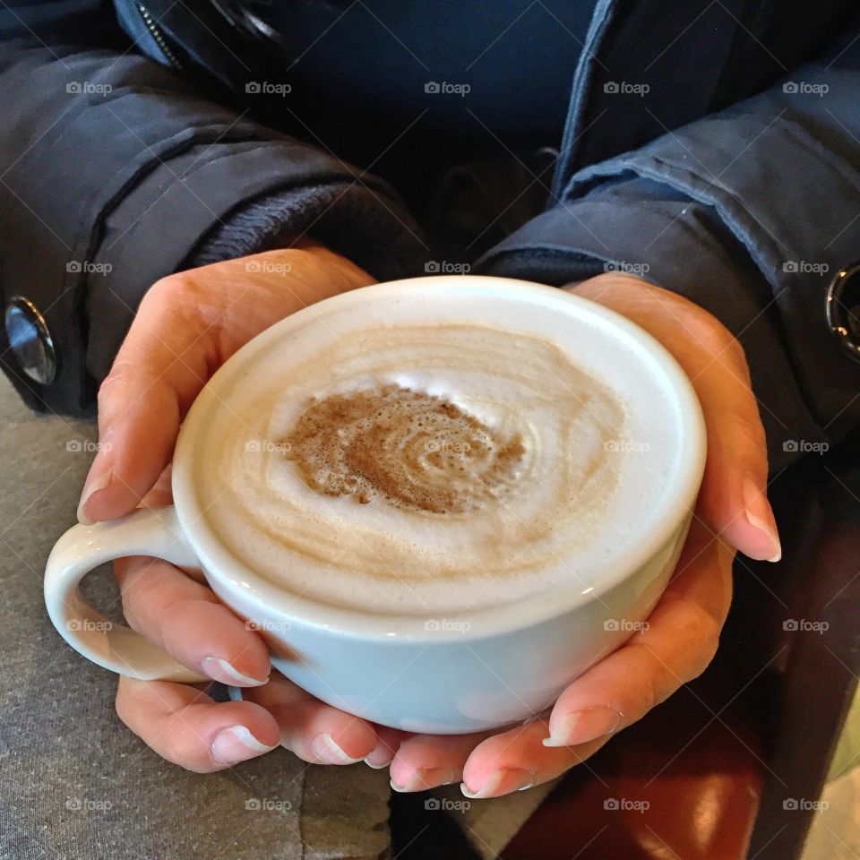 Coffee cup held by female hand