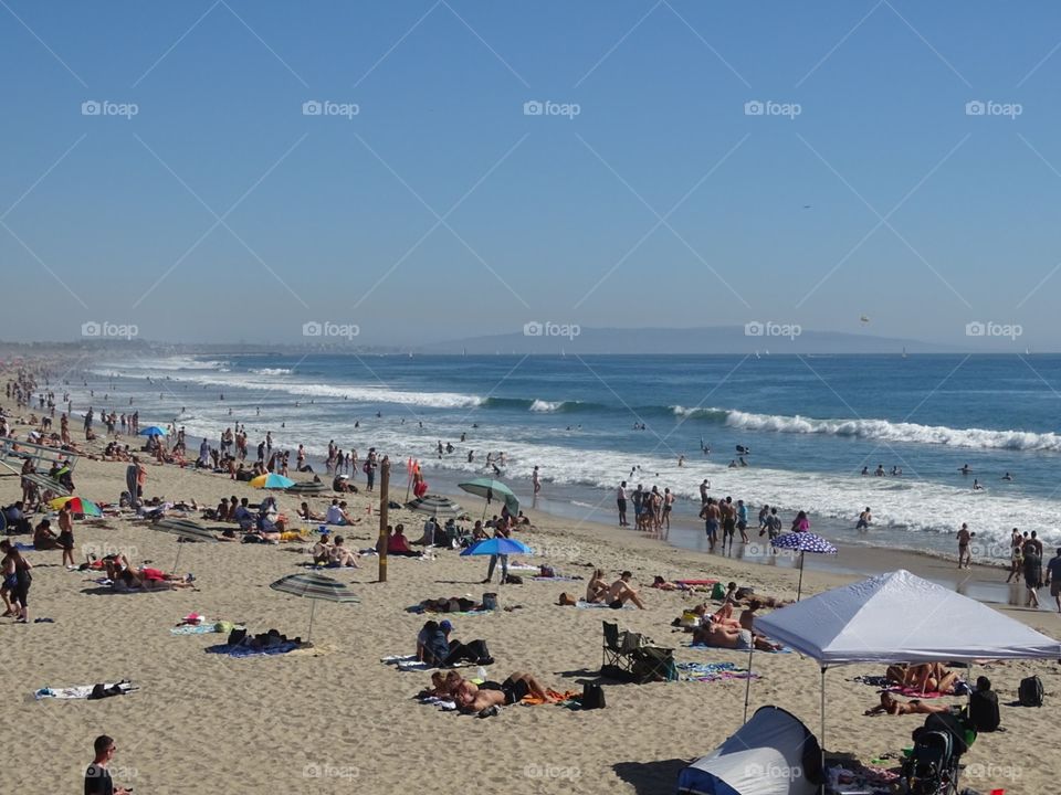 Santa Monica Beach and the people enjoying the waves.