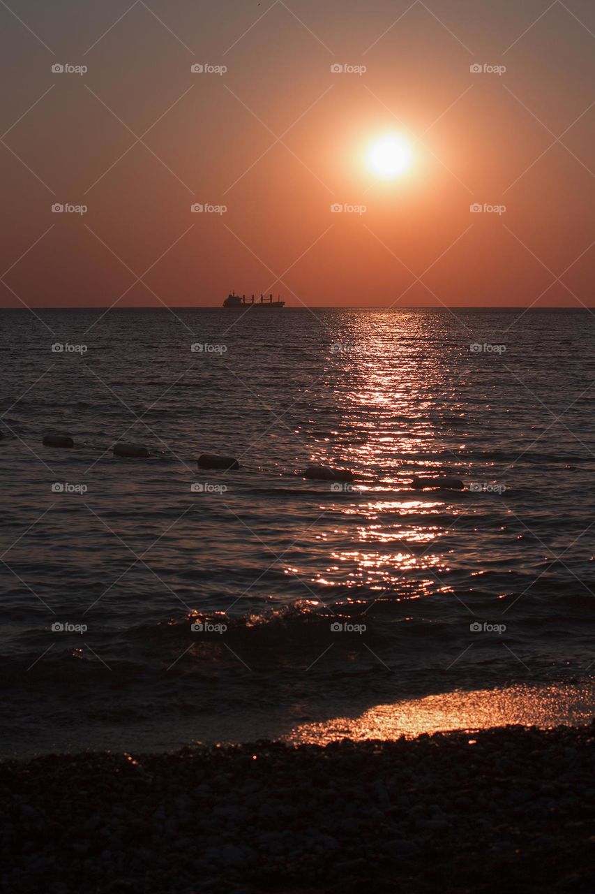 Cargo ship in sunset