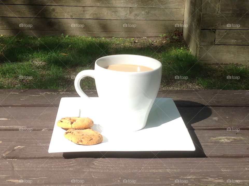 Enjoying a cup of coffee outdoors on a beautiful spring day.