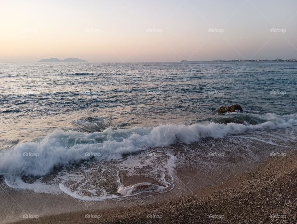 Gentle sea sunset with turbulent waves