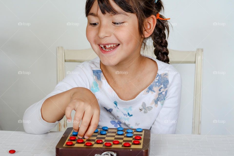 Happy cute girl with M&Ms chocolate