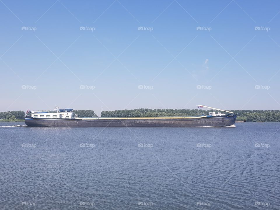 A lighter boat; A lighter is a small ship in which the goods are transferred from a large ship.