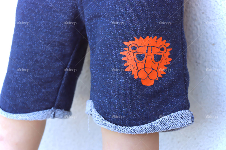 Blue kid pants with orange lion head