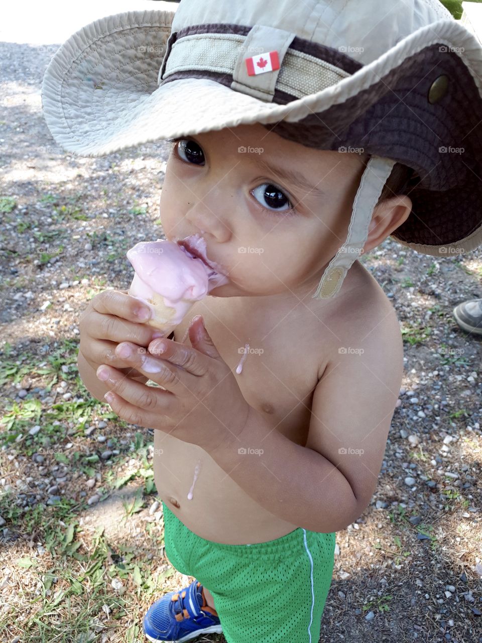 Young boy eating ice cream on a cone