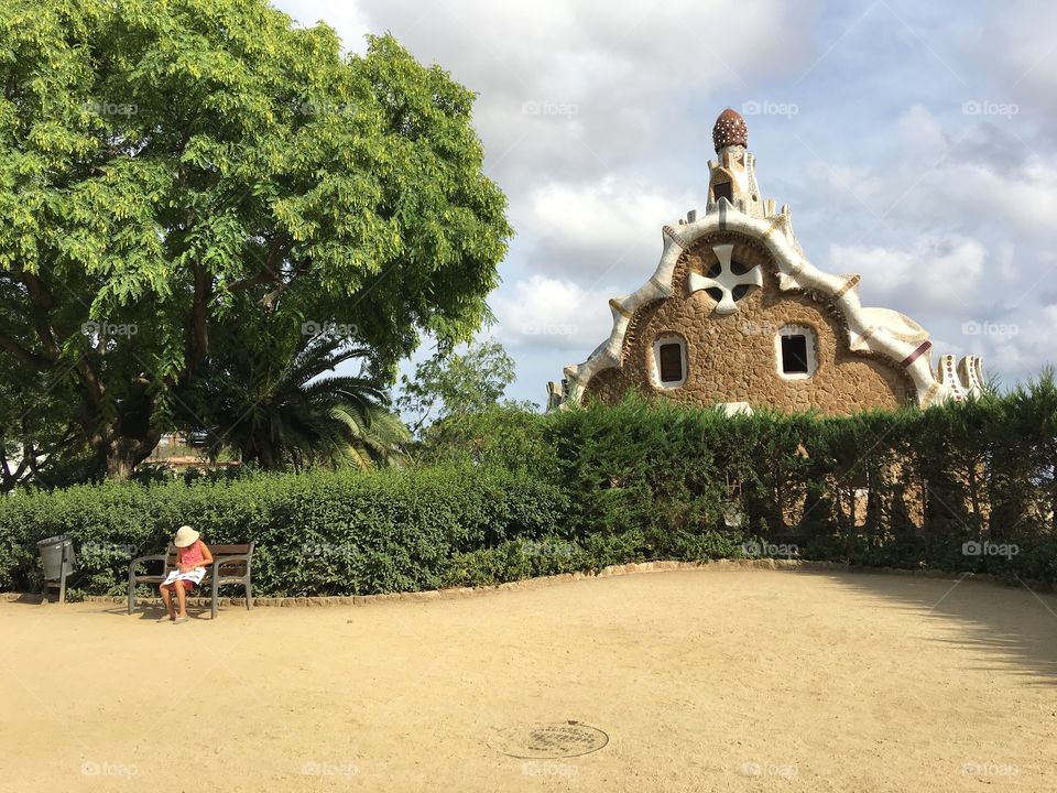 Girl taking a break on bench at gaudi park 