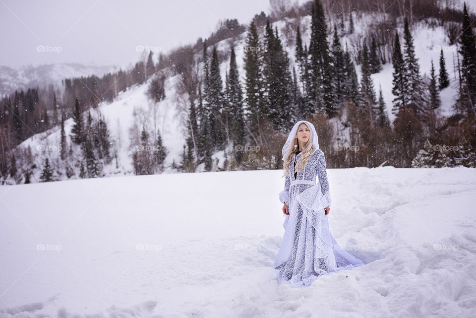 Young woman standing in snow at winter