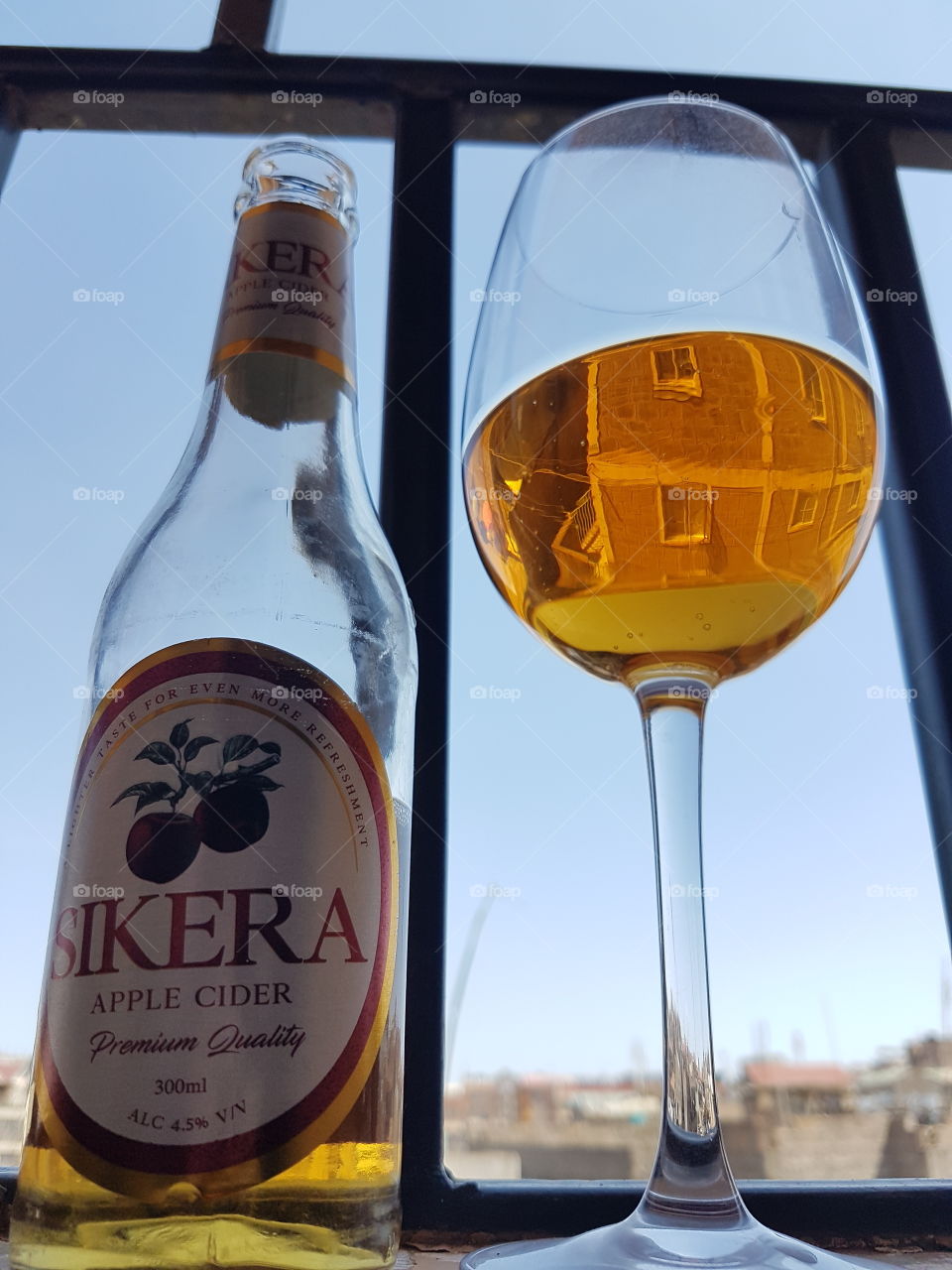 Enjoying a beer at the comfort of my balcony on a warm evening.