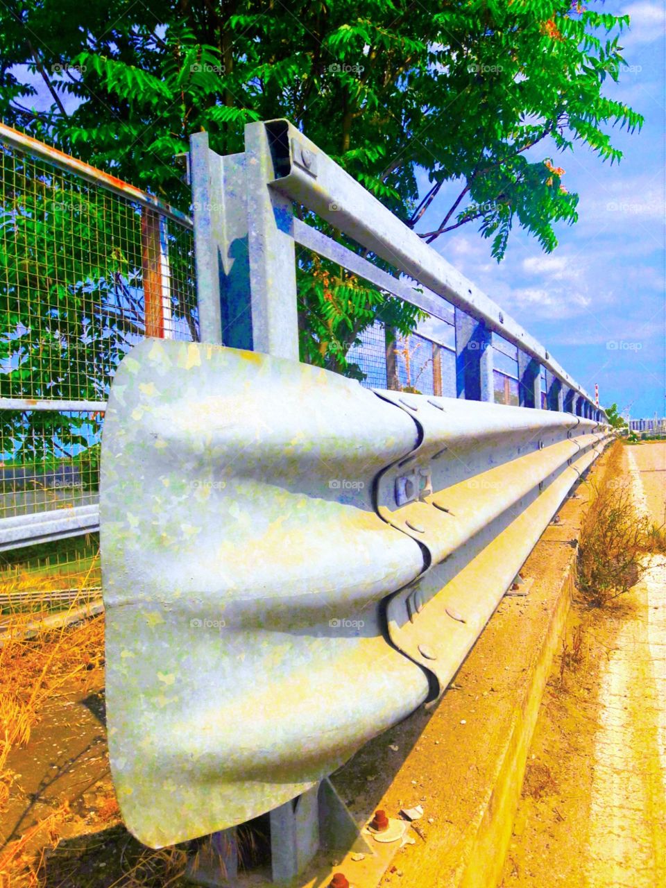 guardrail under a blue sky