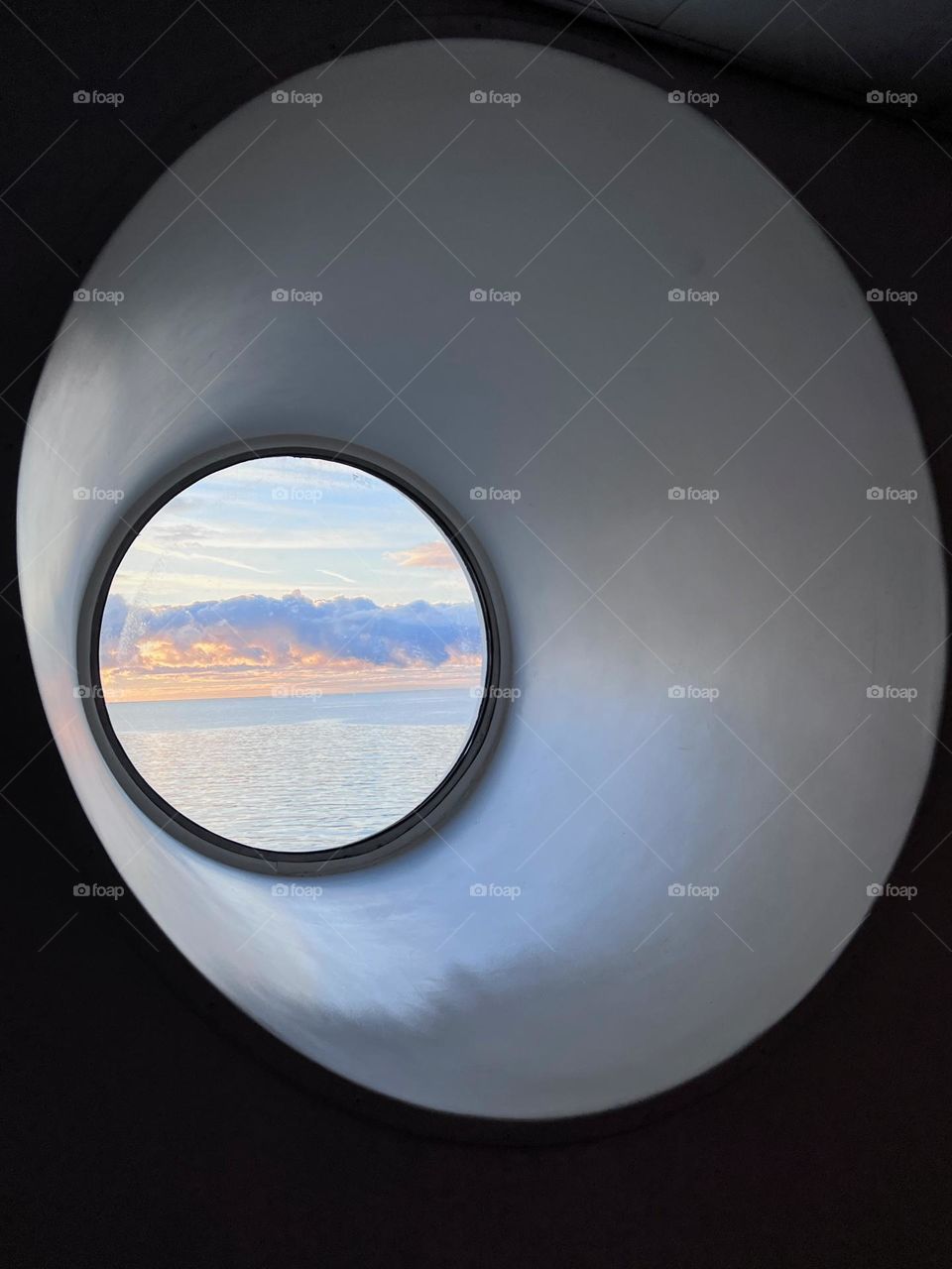 Beautiful landscape seascape view from the circle shaped window at the end of tunnel windowsill