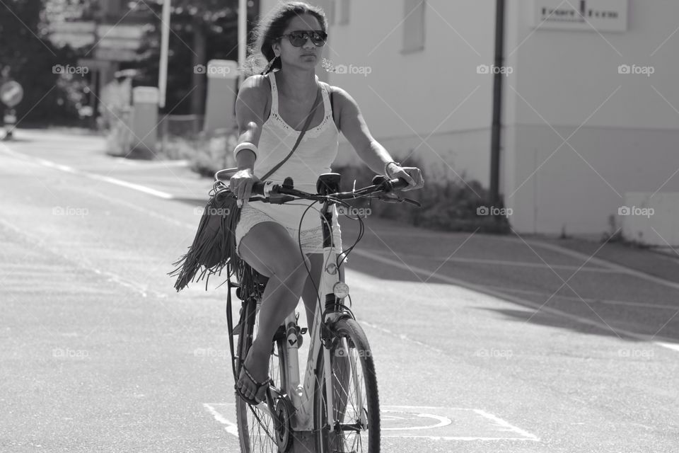 Girl On Bike. Street shot of a young girl riding a bike.