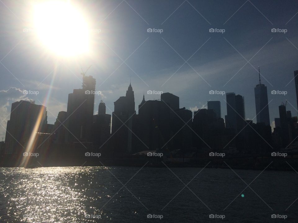 New York City Manhattan Midtown Downtown silhouette skyline landscape backlit sun panoramic view from East River 