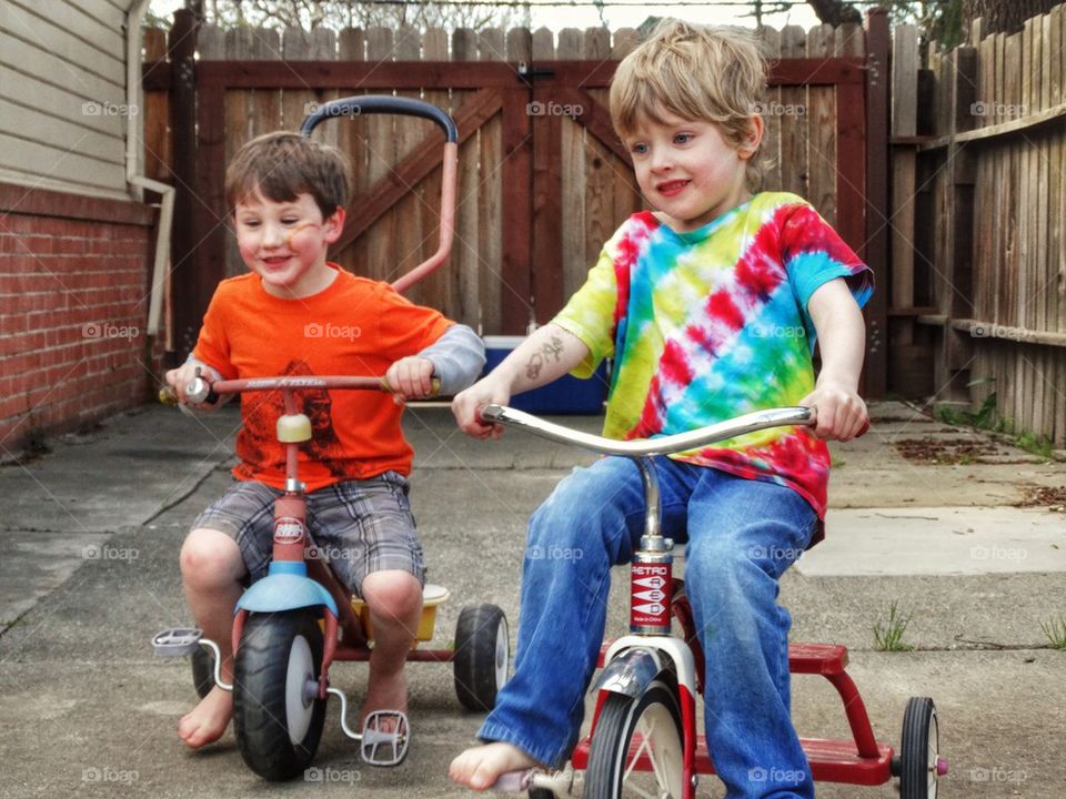 Young Boys Riding Trikes
