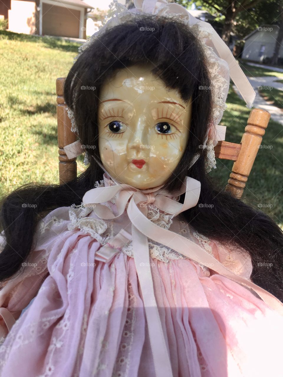 Antique doll dressed in pink