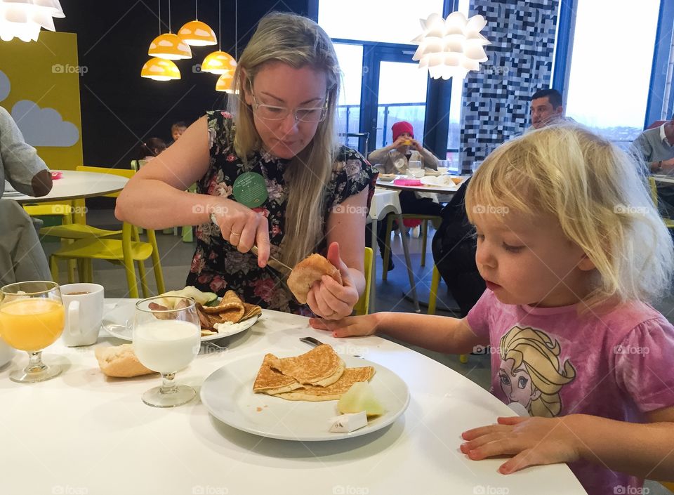 Family having Breakfast and brunch at IKEA restaurant in Malmö Sweden.