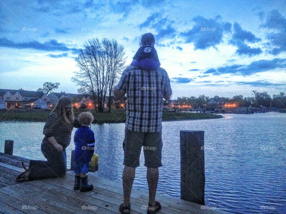 Family by the lake at night 