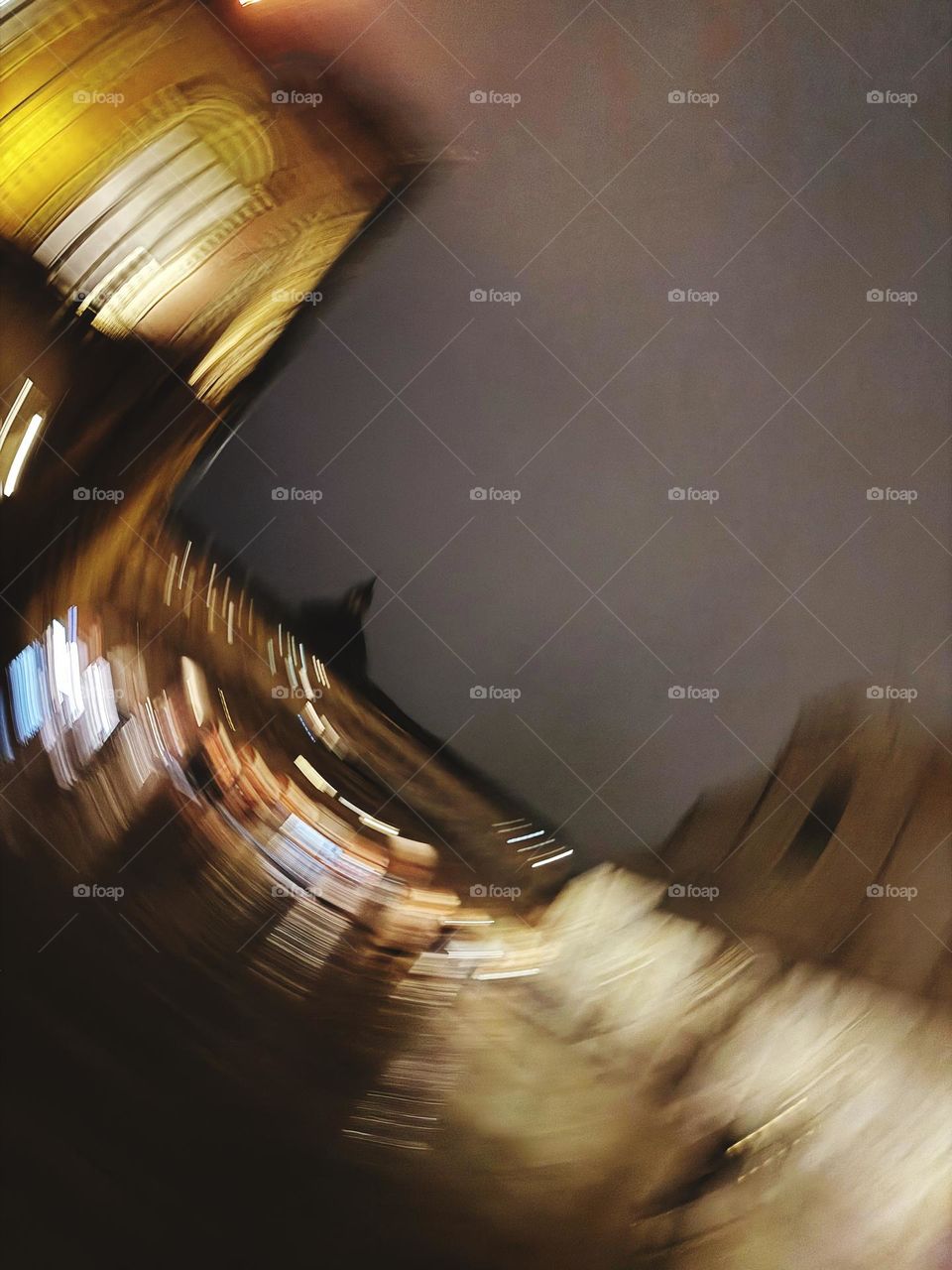 Night street in Bologna, Italy, captured with dynamic motion. Warm light contrasts with dark sky, old architecture and shadows create mysterious atmosphere 