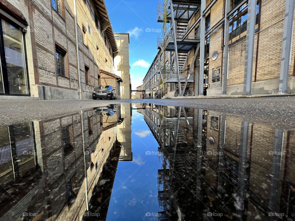 Reflection of old industry buildings in a puddle