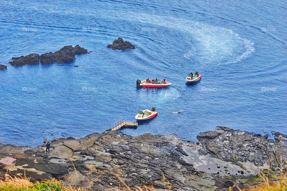 motor boats transport tourists around Jeju island in South Korea
