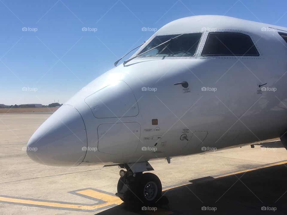 Nose and cockpit of a South African Express De Havilland DHC8-400 series aircraft on the tarmac at Bram Fischer International Airport, Bloemfontein, South Africa. In early Spring.