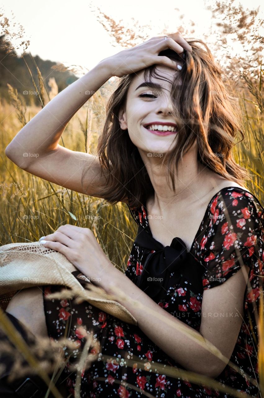 Close-up portrait of a girl. A girl with her hair tied up is caught in the light.