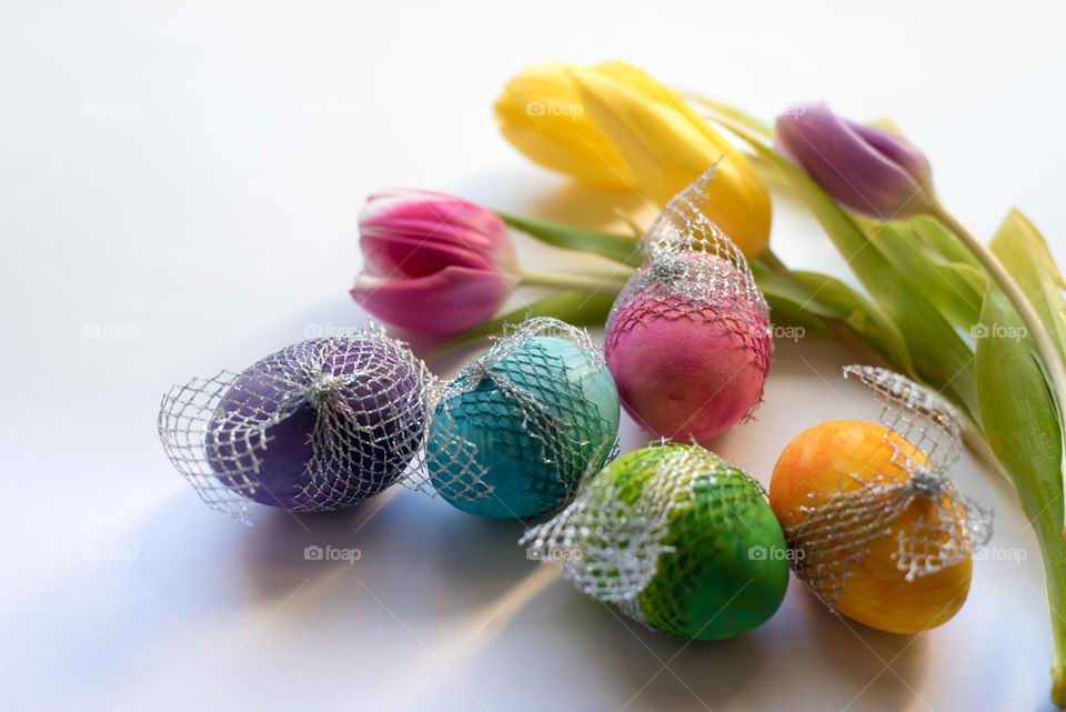 Easter time, spring flowers and colored eggs