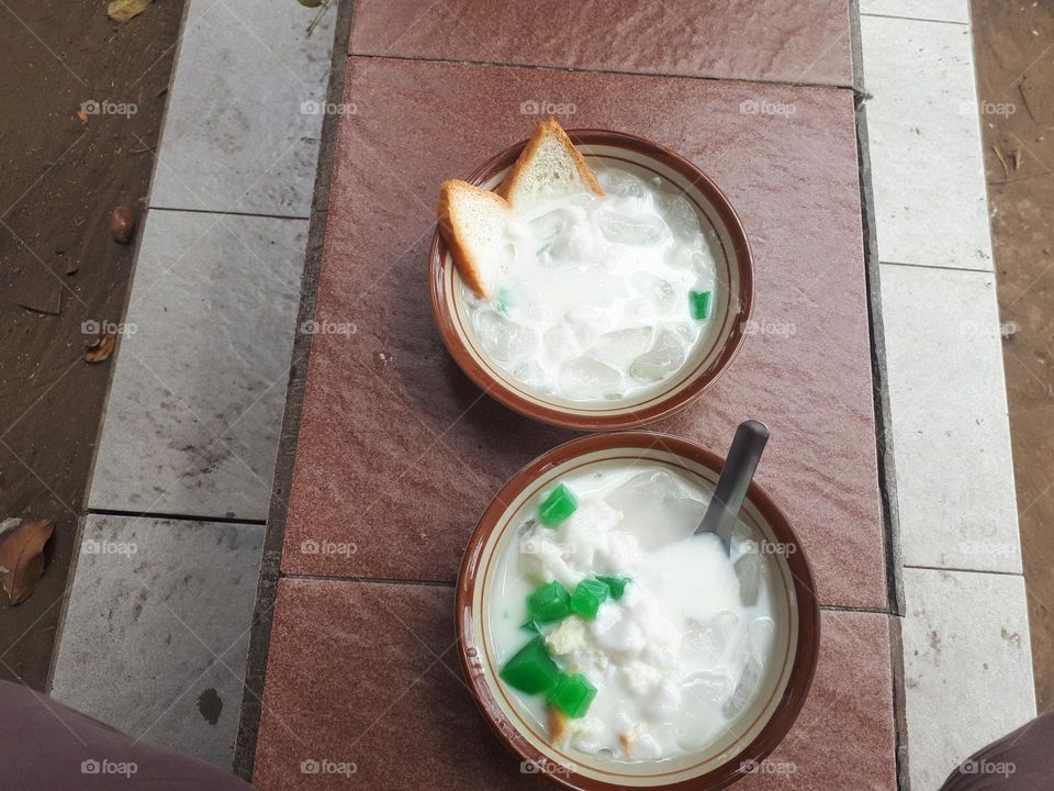 green banana ice, which consists of a variety of marrow porridge, pudding, ice cubes, plain bread, nuts, bananas cut into small pieces, is a delicious and cheap drink in Indonesia