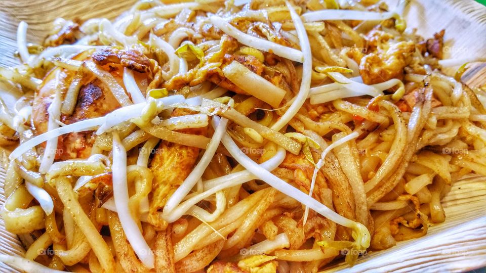 Stir fried rice noodles with bean sprouts and fresh shrimp. A popular food item in Asia, particularly Southeast Asia.