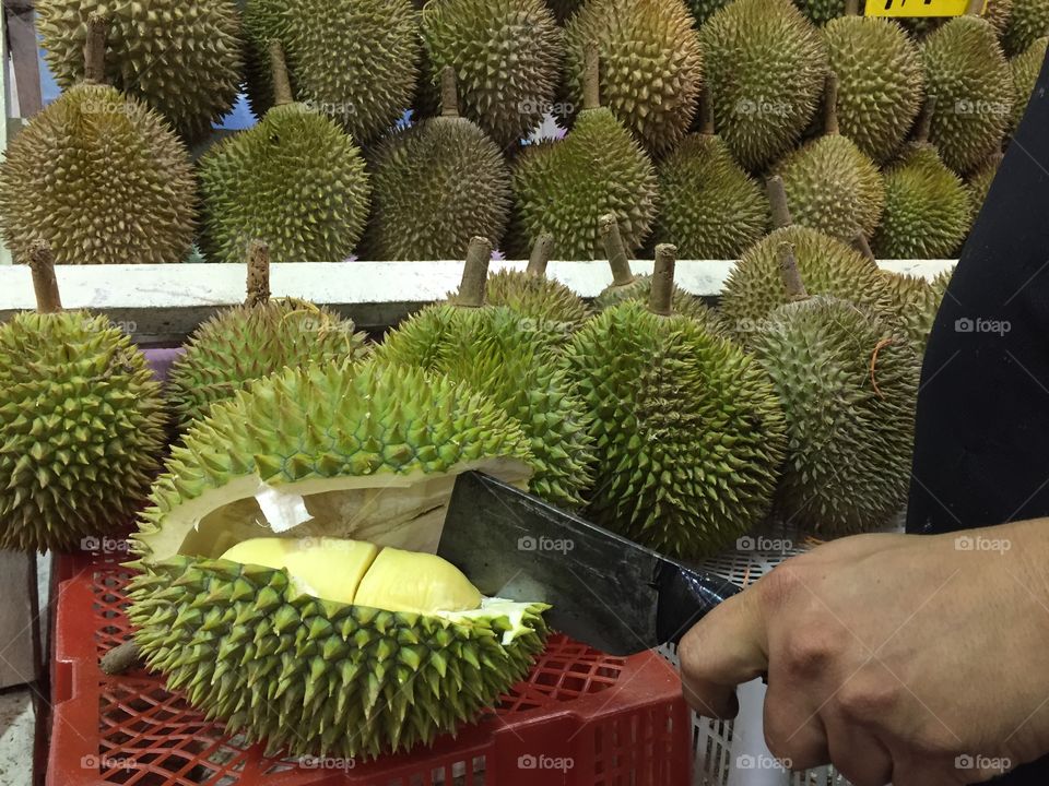 Peeling a durian at the Bukit Timah Market