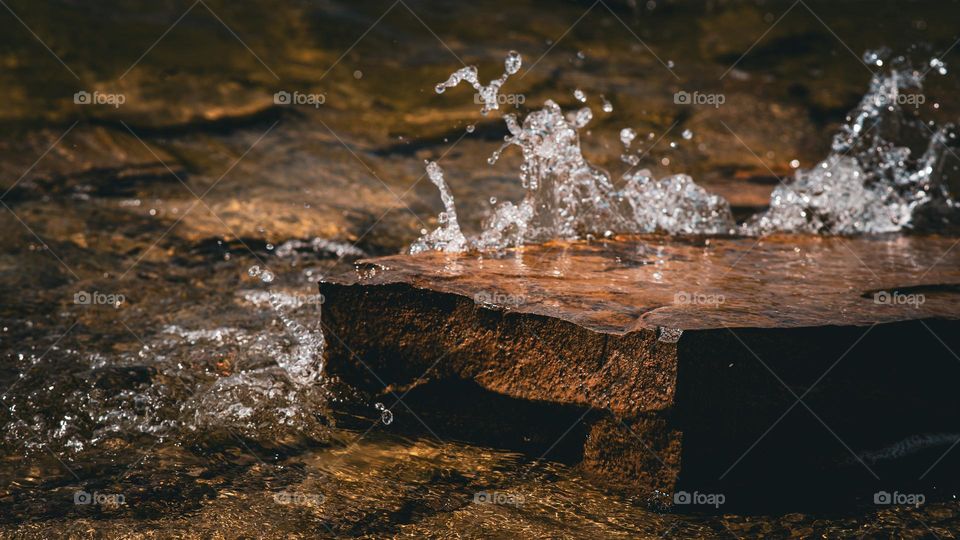 Water’s rise onto stone.