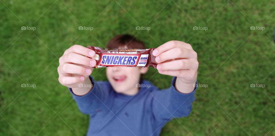 boy holding snickers