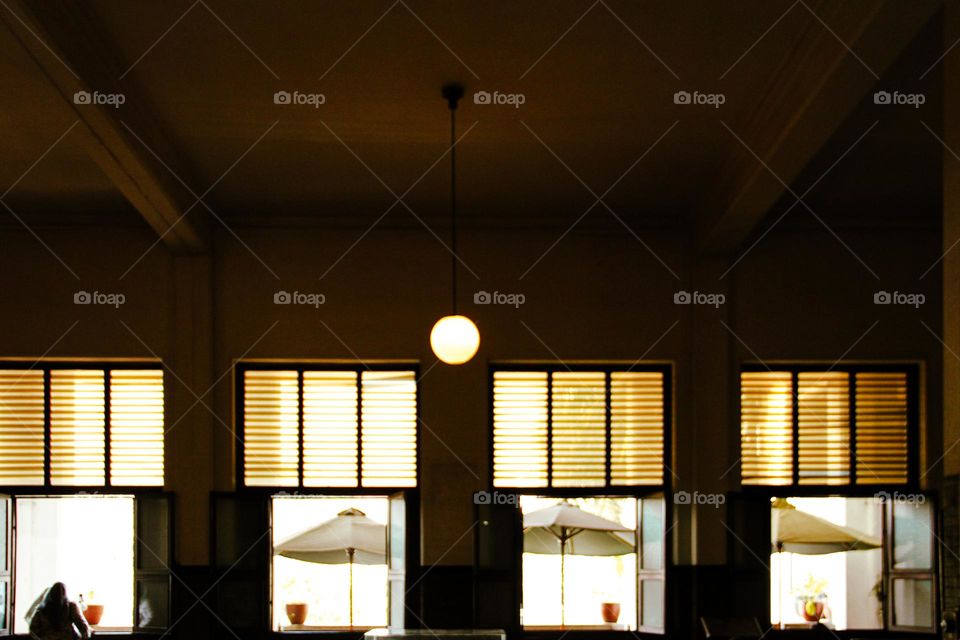 Portrait of a classic European style wooden window in a white-walled building, a green wooden window with white trim built during the Dutch colonial period in an old building in Jakarta.