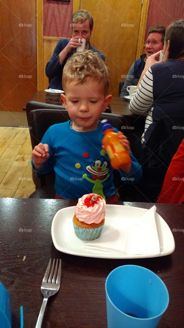 Boy and his cupcake