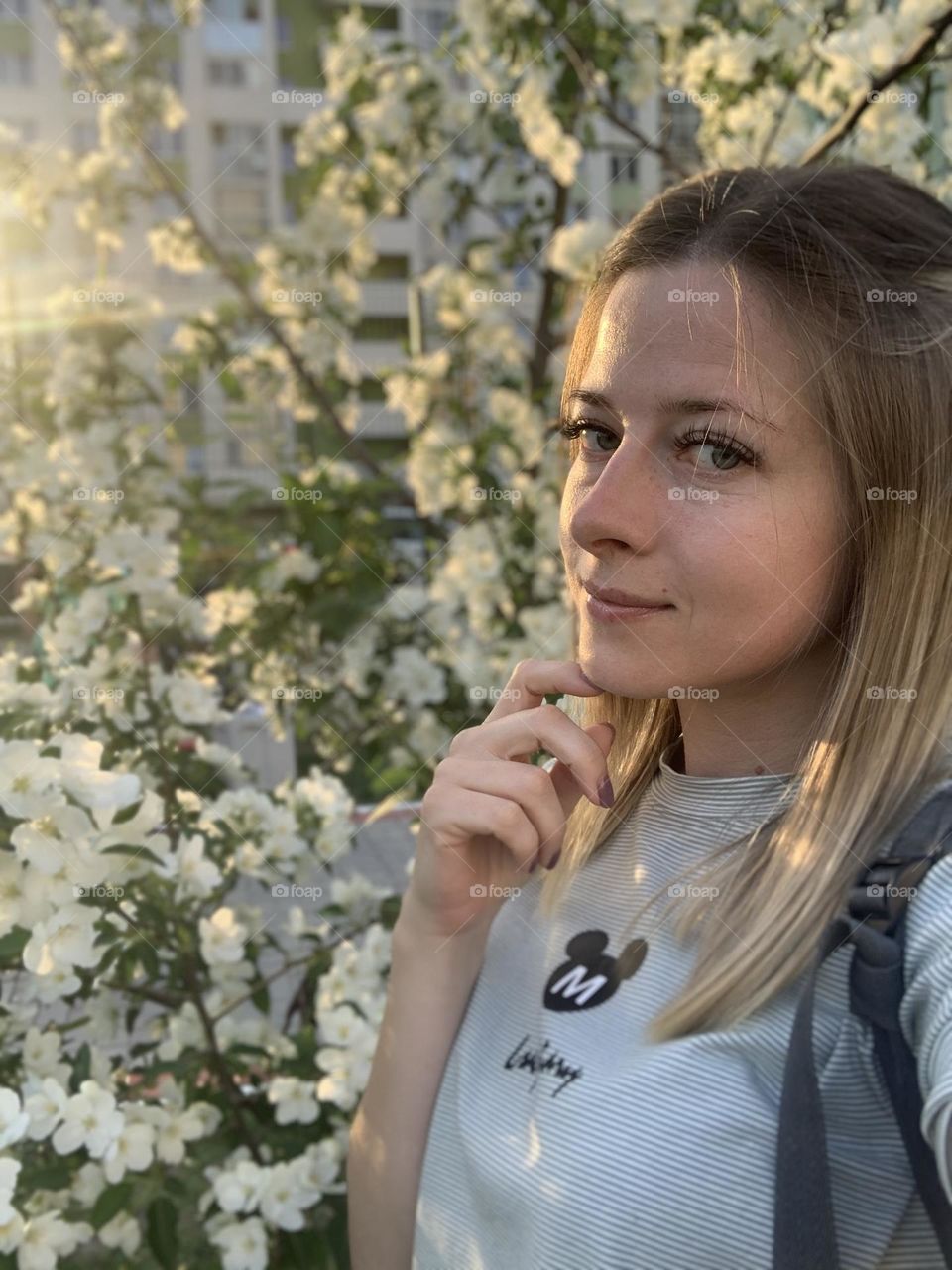 portrait of a girl on the background of apple blossoms, spring