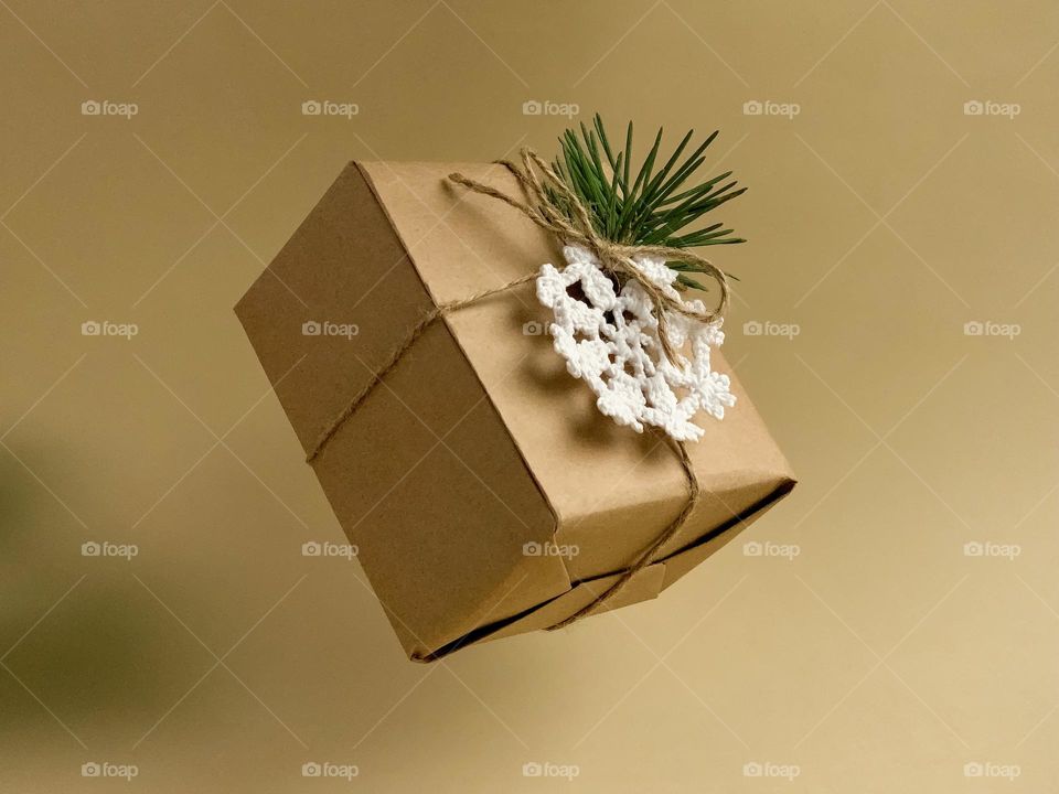 Gift box, knitted snowflake, pine branch, levitation