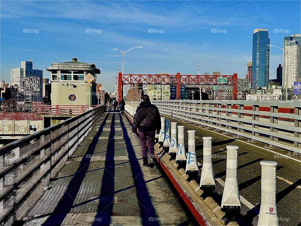 The “Pulaski Bridge” is a marvel of modern design. Its repetitive shapes cast varied dramatic shadows depending on the time of day such as these pronounced parallel lines receding towards a single point in the distance. 2023. Hypnotic Productions