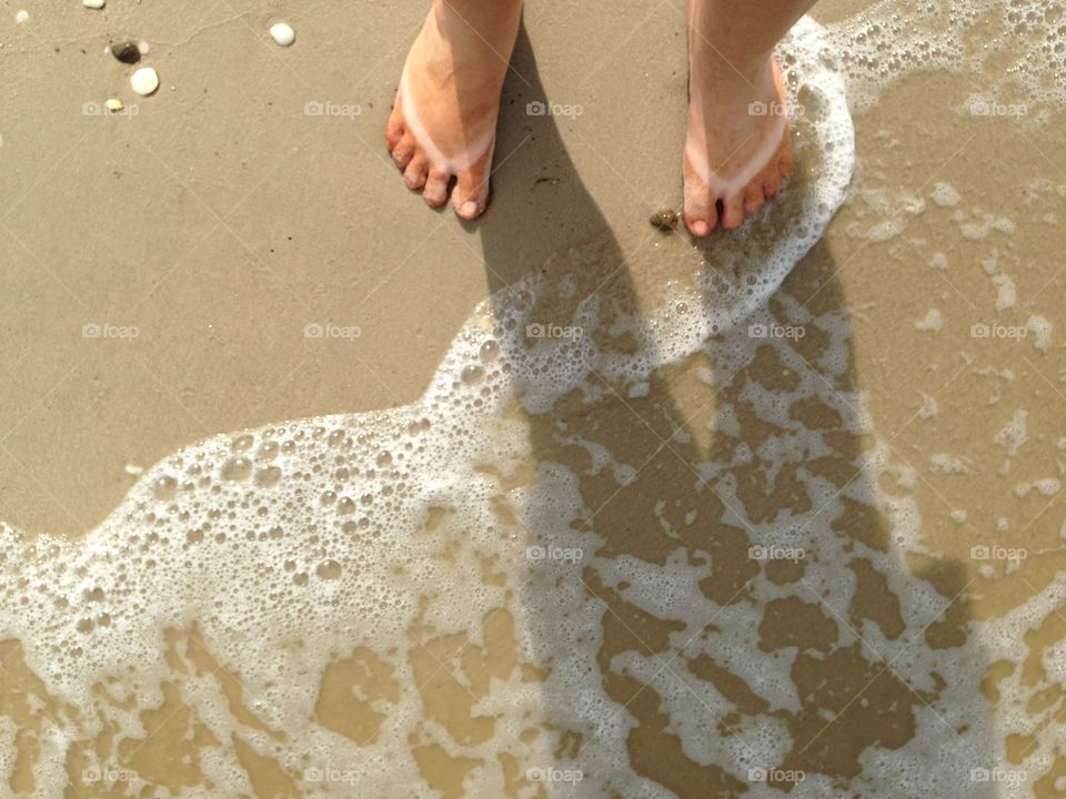 Tan lines at the shoreline. 