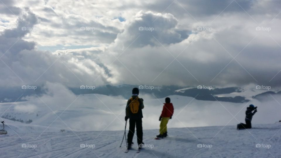 skiers in clouds