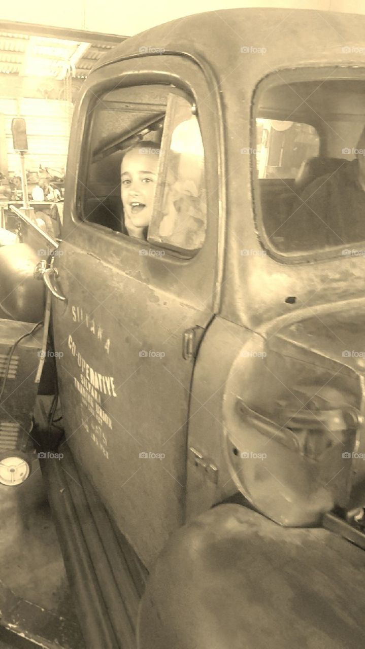 little girl in old truck